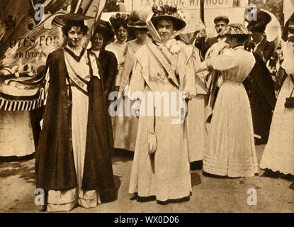 Christabel Pankhurst and Emmeline Pethick-Lawrence, Hyde Park, London, 21 June 1908, (1933). British suffrage campaigners Christabel Pankhurst (1880-1958) and Emmeline Pethick-Lawrence (1867-1954) at a rally on 'Women's Sunday'. Suffragettes protested through direct action and civil disobedience, achieving partial suffrage in 1918. It was not until 1928 that all women finally gainied the right to vote. From &quot;The Pageant of the Century&quot;. [Odhams Press Ltd, 1933]