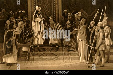 Jesus before the Sanhedrin, 1922. Jesus (Anton Lang) is tried before an assembly of rabbis: players in the Oberammergau Passion Play. The play is performed every 10 years, on open-air stages, by the inhabitants of the village of Oberammergau in Bavaria, Germany. First staged in 1634, the play tells the story of Jesus' passion, culminating in his crucifixion. The event has become a tourist attraction, with audiences coming from all over the world. Official postcard of the 1922 Oberammergau Passion Play. [F. Bruckmann, Munich, Germany, 1922] Stock Photo