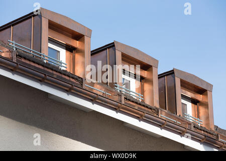 three copper dormers on rooftop Stock Photo