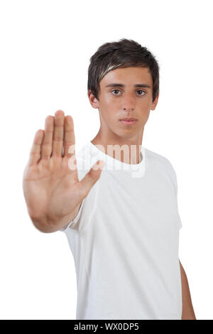 young swarthy man with brown eyes makes stop gesture/holds up hand Stock Photo