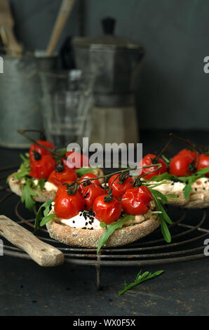 toast roll with cream cheese, rocket and tomatos Stock Photo