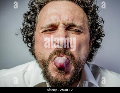 derision, man with intense expression, white shirt Stock Photo