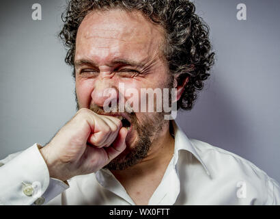 derision, man with intense expression, white shirt Stock Photo