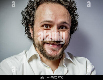 derision, man with intense expression, white shirt Stock Photo