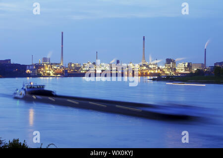 shipping on river Rhine and Chempark in Uerdingen in twilight, Krefeld, Lower Rhine, Germany, Europe Stock Photo