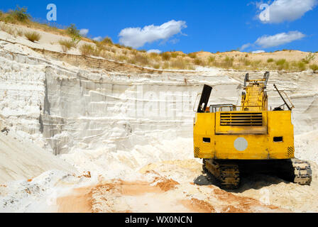 Old yellow dredge in sandy to career Stock Photo