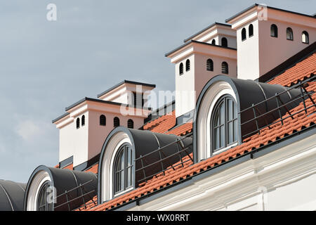 Red tile roof with a windows. Vilnius, Lithuania Stock Photo