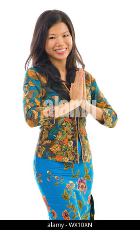 Southern Thai woman in a traditional welcoming gesture over white background Stock Photo