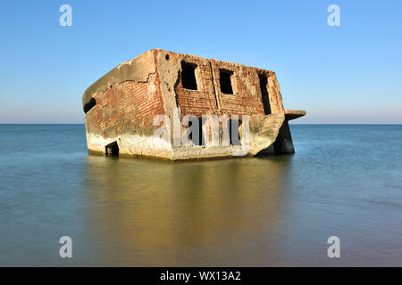 Ruins of bunker on the beach of the Baltic sea, part of an old fort in the former Soviet base Karosta in Liepaja, Latvia Stock Photo