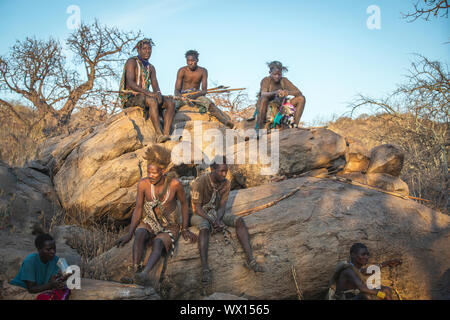 Lake Eyasi, Tanzania, 11th September 2019: Hadzabe men resting on a rock Stock Photo