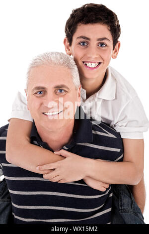 Grandfather piggybacking his grandson on isolated background Stock Photo