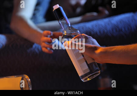 Two young men get drunk at home Stock Photo