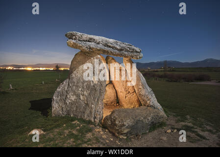 Prehistoric megalithic dolmen at night in the north of Spain, starry night in the background. Stock Photo