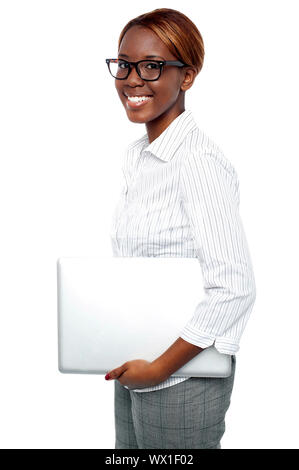 Side view of cheerful business consultant carrying laptop isolated against white background Stock Photo
