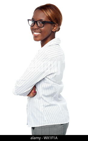 Isolated african business executive smiling with crossed arms. Side view Stock Photo
