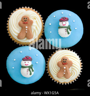 Christmas cupcakes isolated against a black background Stock Photo