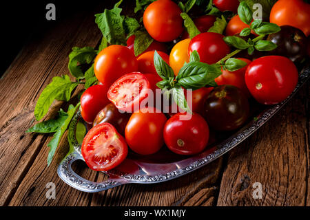 various types of tomatoes served and presented on the silver platter. Stock Photo