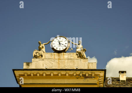 Detail of the roof of the Hotel de Ville (town hall) in Emile Chanoux square with statues and a clock against blue sky, Aosta, Aosta Valley, Italy Stock Photo