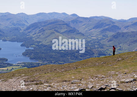 A young boy(7 yrs old) high on Skiddaw in the Lake District with Keswick and Derwent Water below Stock Photo