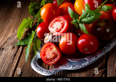 various types of tomatoes served and presented on the silver platter. Stock Photo