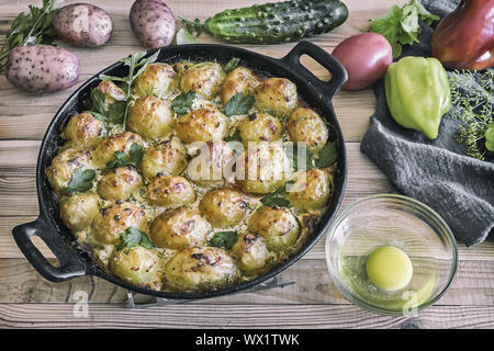 Young potatoes with cottage cheese are baked in the oven.
