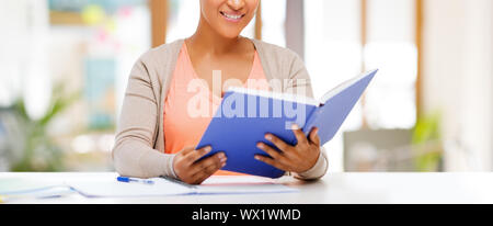 african american female student reading book Stock Photo