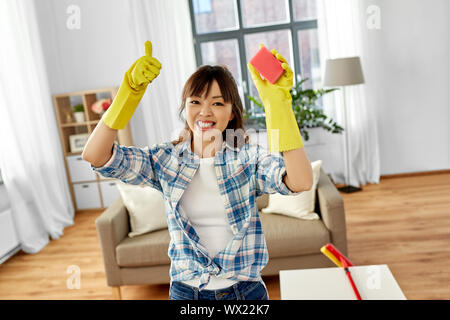 happy asian woman with sponge cleaning at home Stock Photo