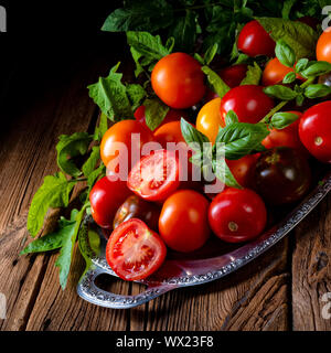 various types of tomatoes served and presented on the silver platter. Stock Photo