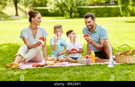 happy family having picnic at summer park Stock Photo