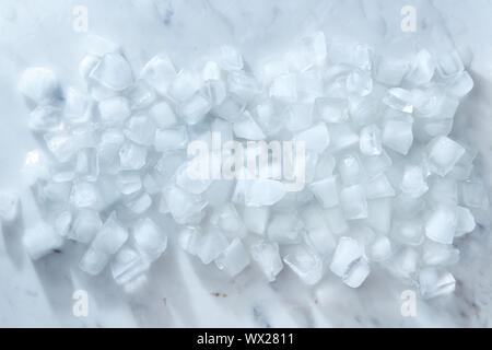 Cubes of ice on a gray marble table. Concept of a cold summer drink. Flat lay Stock Photo