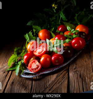 various types of tomatoes served and presented on the silver platter. Stock Photo