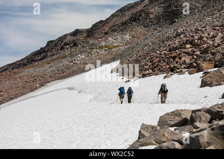 Crossing a snow field along the Pacific Crest Trail below Old Snowy in the Goat Rocks Wilderness, Gifford Pinchot National Forest, Washington State, U Stock Photo