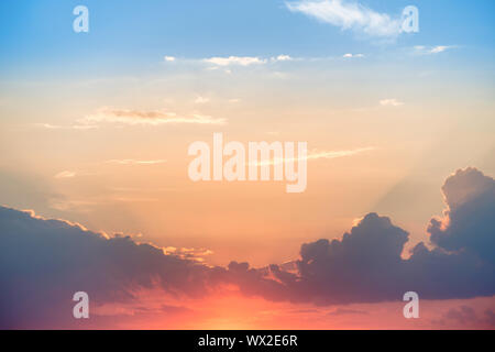 Sunset with sun on blue dramatic sky Stock Photo