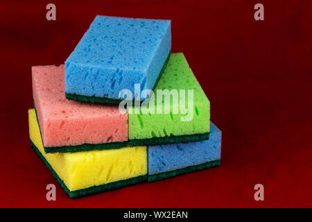 Household cleaning sponges stacked on a red cleaning cloth Stock Photo