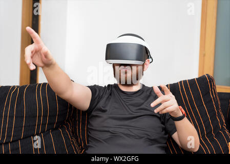 Bearded man wearing virtual reality goggles Stock Photo
