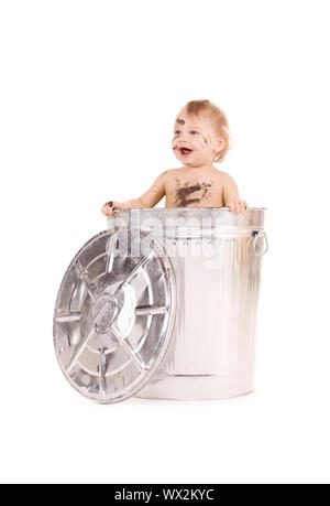 picture of adorable baby in trash can Stock Photo