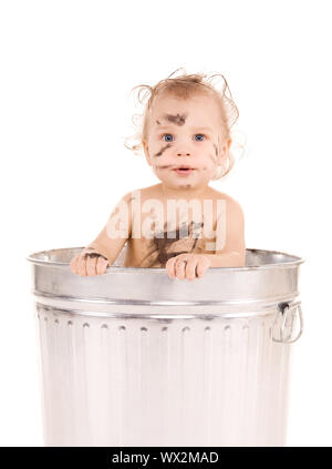 picture of adorable baby in trash can Stock Photo