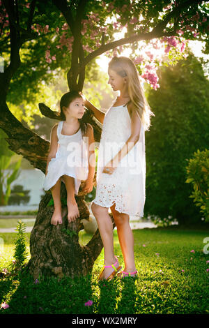 Mother and daughter in a fabulous garden Stock Photo