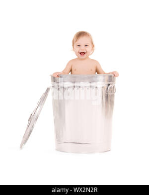 picture of adorable baby in trash can Stock Photo