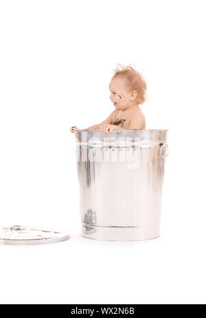 picture of adorable baby in trash can Stock Photo