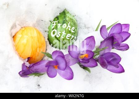 The picture shows a beautiful easter decoration with the german text happy easter. Stock Photo