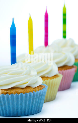 Colorful birthday cupcakes isolated against white Stock Photo