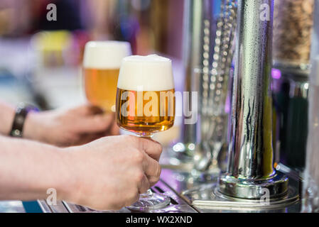 Two beer glasses in the tap of a pub Stock Photo