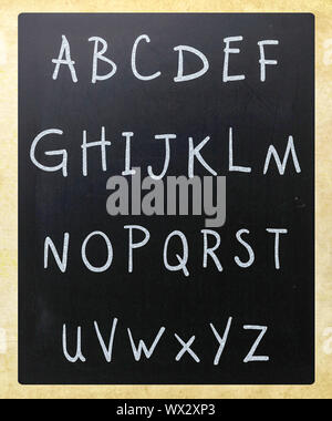 Complete english alphabet handwritten with white chalk on a blackboard Stock Photo