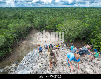 COBA, MEXICO - November, 13, 2013: Group of tourists climbing Nohoch Mul pyramid in Coba, Mexico Stock Photo