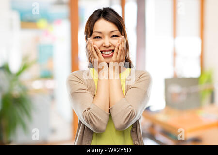 happy amazed asian woman over background Stock Photo