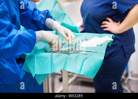 nurse preparing medical instruments for operation