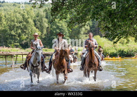 Riders and horses crossing the river Semois near Laferet, Belgium Stock Photo