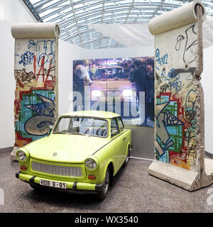 Original Berlin Wall with Trabi and film of the opening of the Berlin Wall in 1989, Bonn, Germany Stock Photo