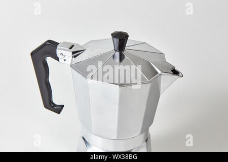 Closeup of metal geyser coffee maker presented on gray background. Stock Photo